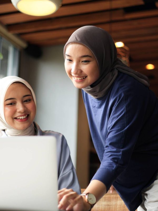 two-muslim-friends-wearing-hijab-working-laptop-coffee-shop (1)